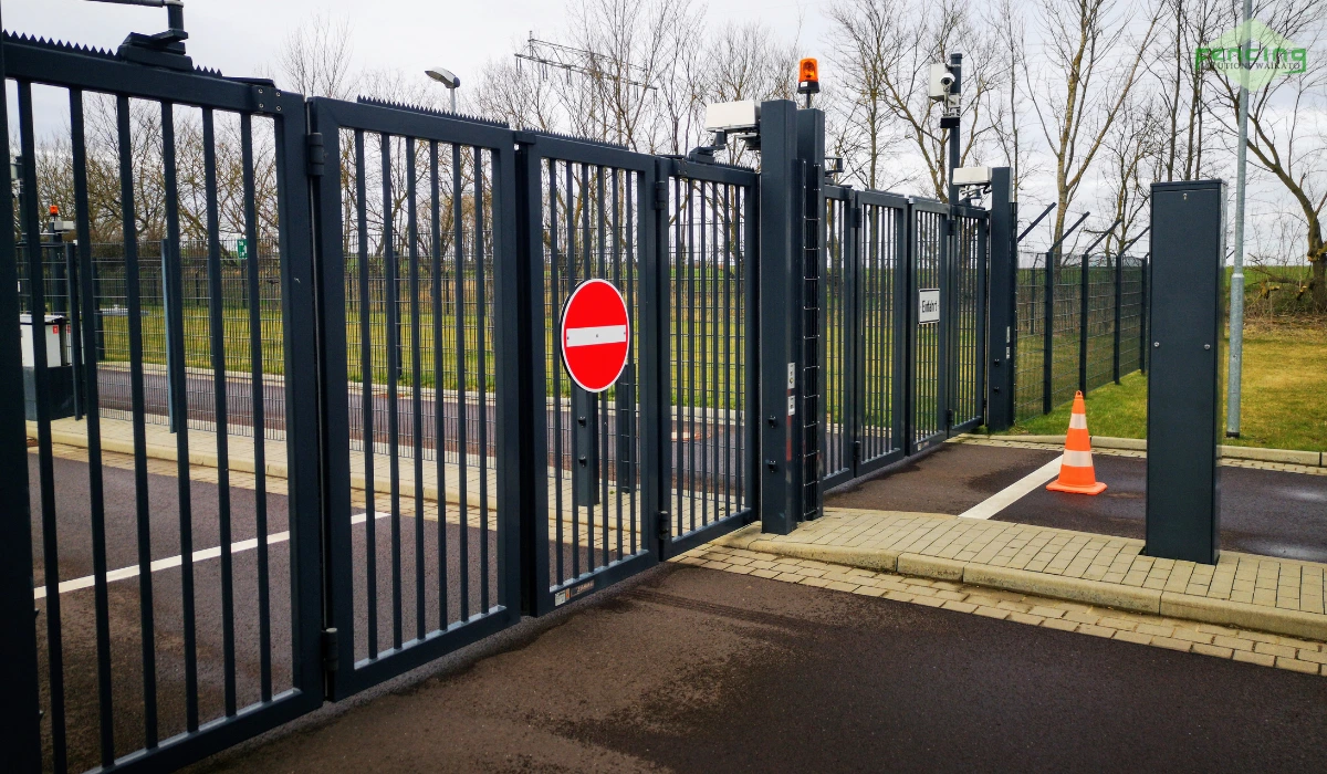 Automated security gate with no-entry sign and traffic bollard.